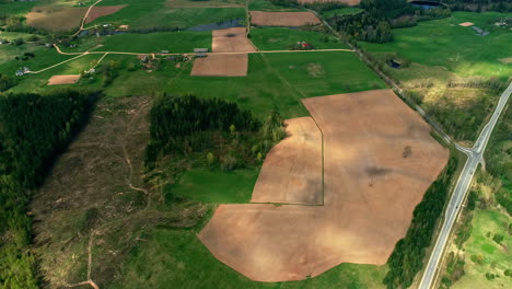 Aerial-view-of-countryside-diverse-textured-landscape-with-roads-and-deforestation