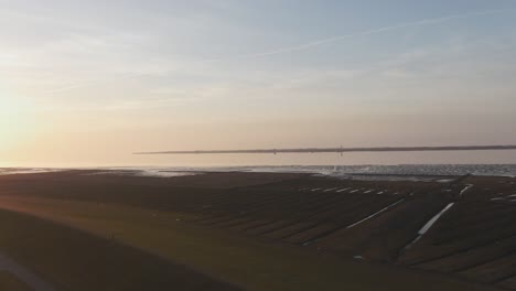 orange skies over north sea coast watt near husum nordfriesland germany