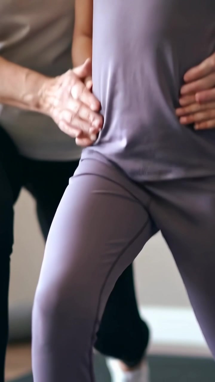 Vertical video: Placing hands, coach guiding child lunging at home, exercise, lavender set and mat