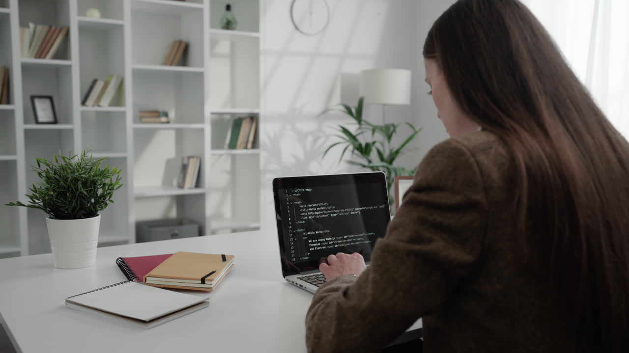 Woman programming on laptop
