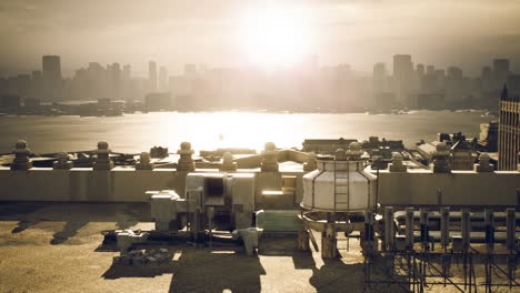 city skyline viewed from industrial area during sunset over the water