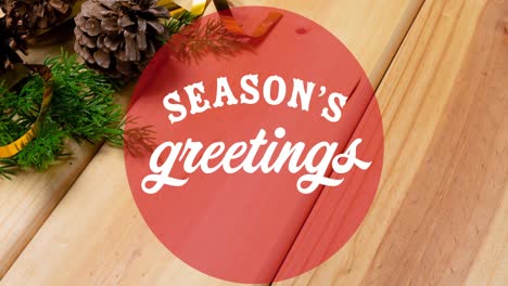 Animation-of-seasons-greetings-christmas-text-in-circle-on-wooden-background