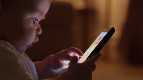 baby captivated by a glowing smartphone screen