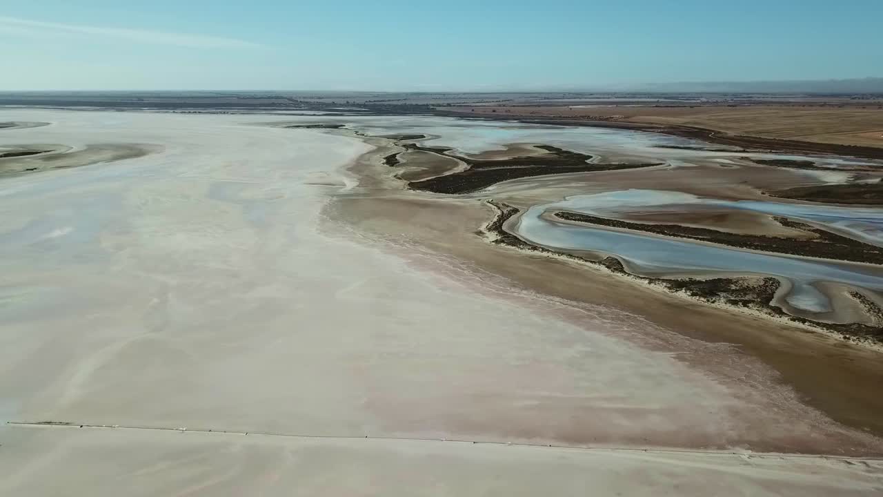 Aerial footage moving sideways of landforms near the edge of Lake Tyrell, in north-west Victoria, May 2021.