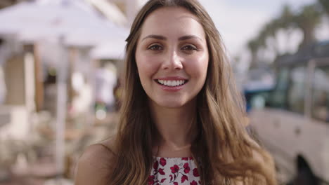 portrait-of-beautiful-young-woman-smiling-running-hand-through-hair-feeling-confident-happy-enjoying-vacation