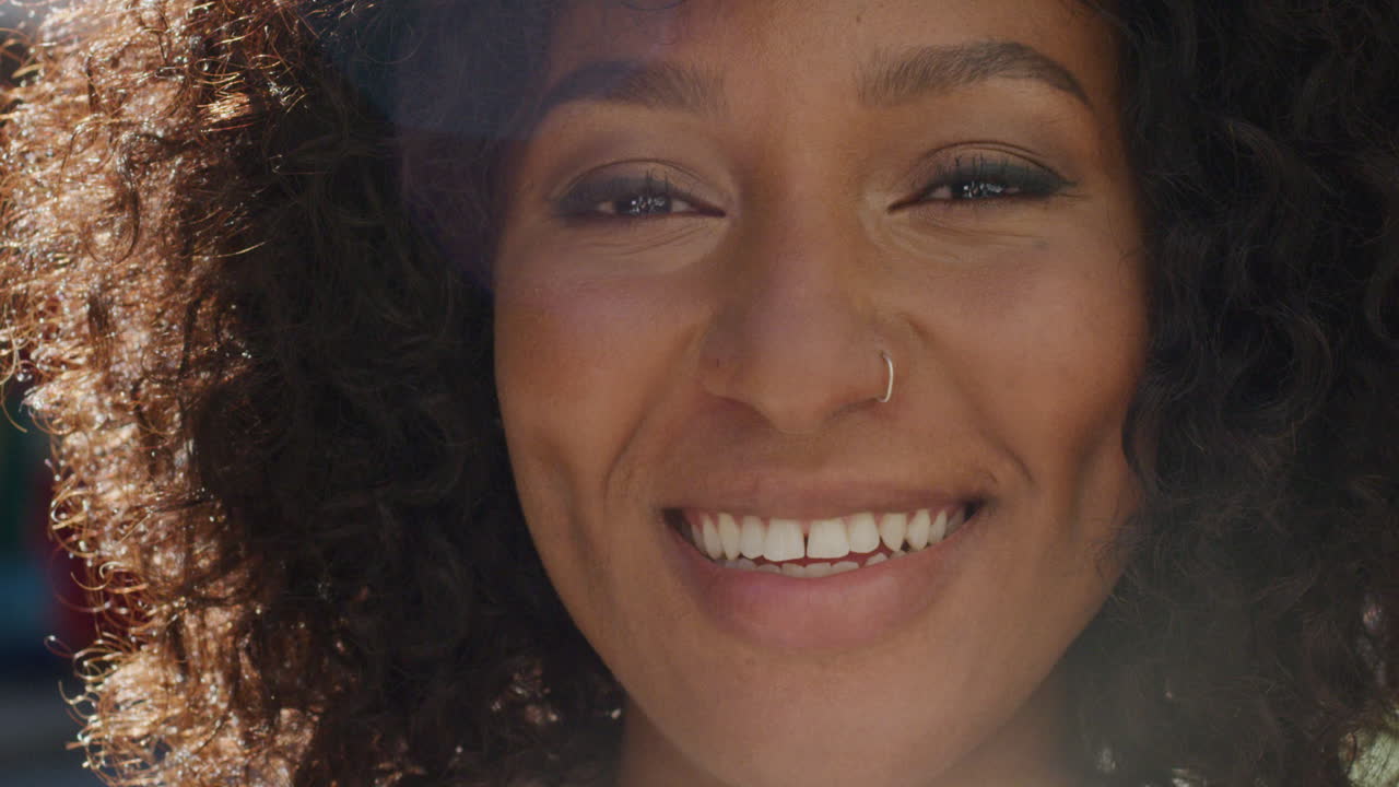 Portrait happy african american woman smiling in city