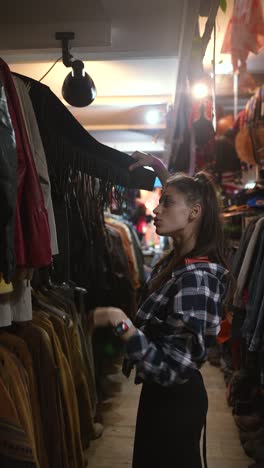 woman shopping for clothes in a vintage clothing store