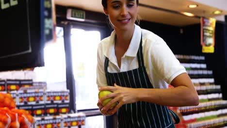 Female-staff-arranging-fruits-in-organic-section