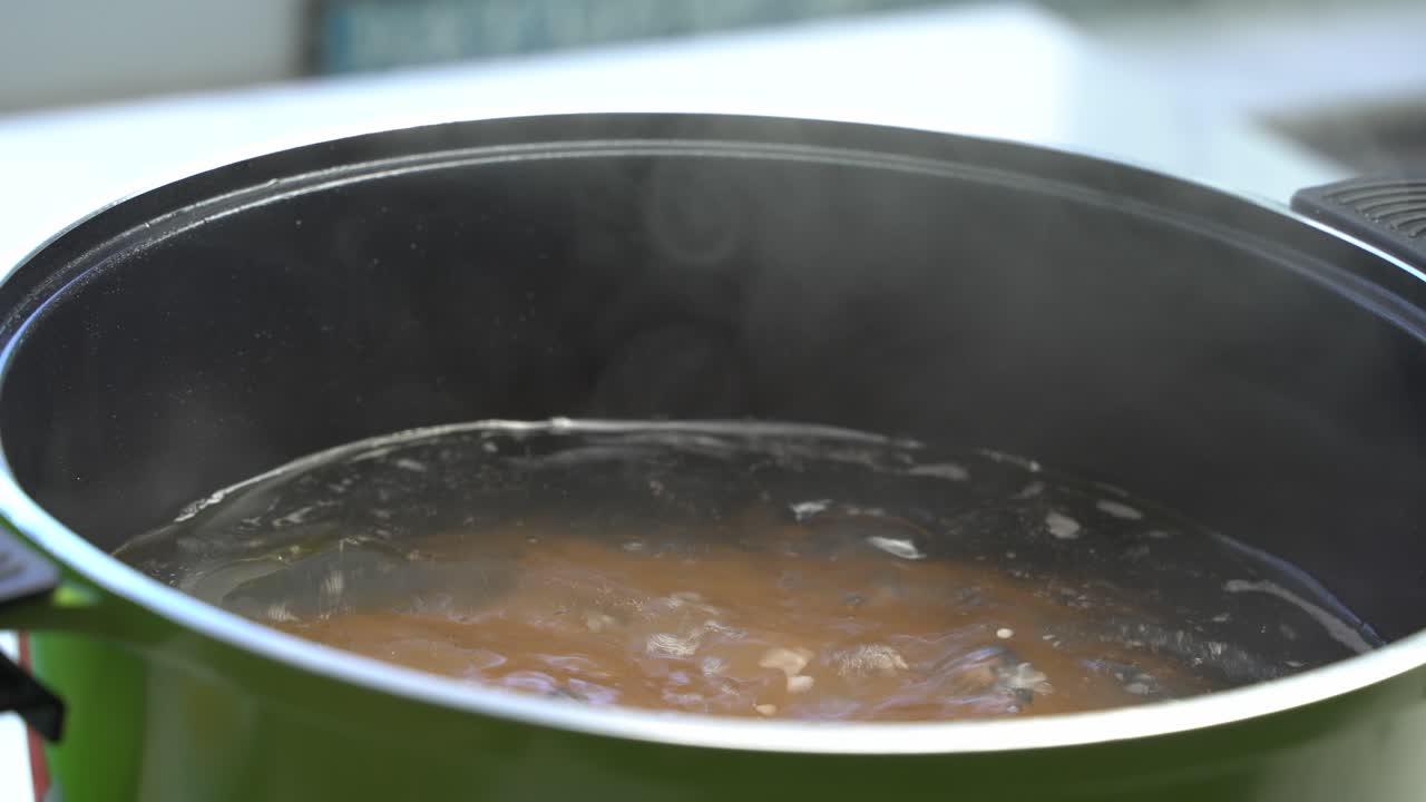 Hot pot of spaghetti cooking with bubbles and steam, pasta preparation, close up