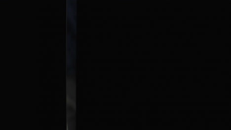 person looking out of a dark doorway