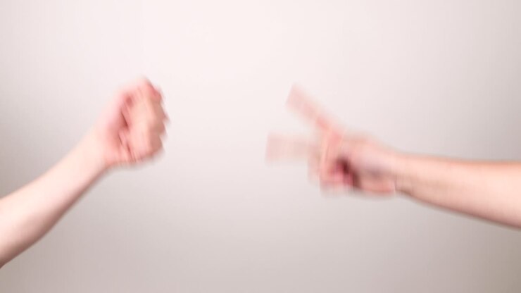Two hands doing the game rock paper scissors