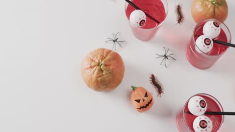 video of halloween drinks and decorations with copy space on white background