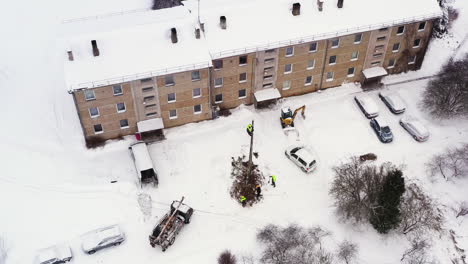 electricity pole replacement for an apartment building in winter, aerial view