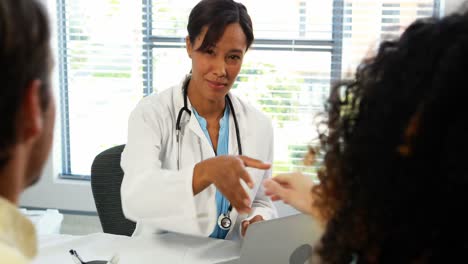 pareja hablando con el médico en la clínica