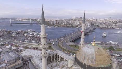 beautiful aerial through spires of mosque reveals bosphorus river and the city of istanbul turkey