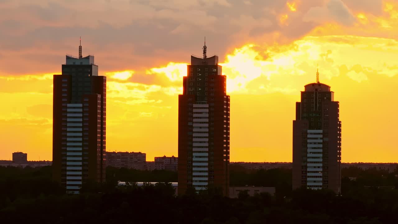 Golden sunset silhouette reveals Riga’s modern skyline in calm cinematic glide