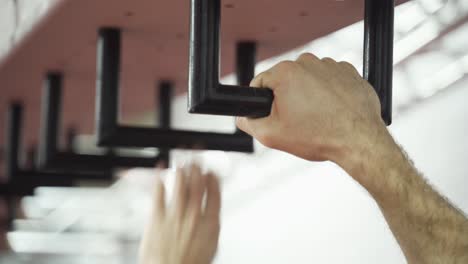 man climbing the monkey bars. close up