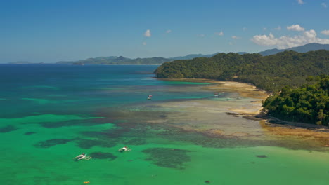 panoramic view of tropical beach with clear turquoise waters and lush islands