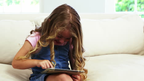 Cute-girl-smiling-and-using-a-tablet