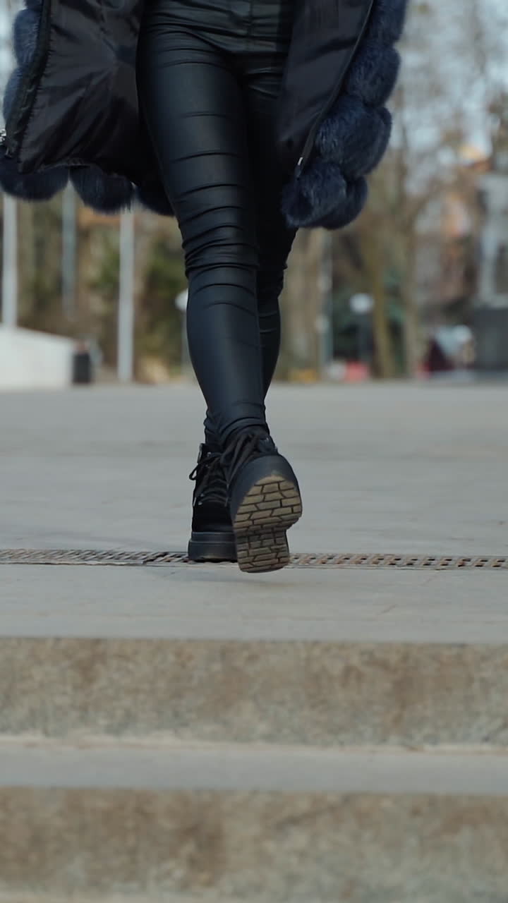 Woman in Black Boots Jumping on Stairs