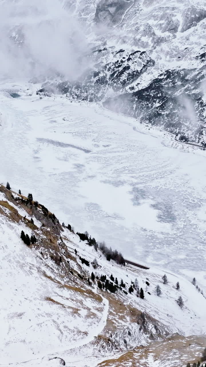 Aerial drone view of Portavescovo covered in snow, in Arabba, Italy. Vertical
