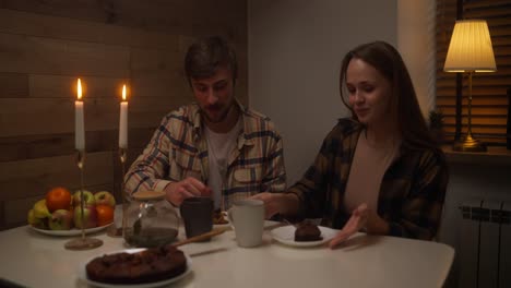 couple enjoying a cozy dessert dinner at home