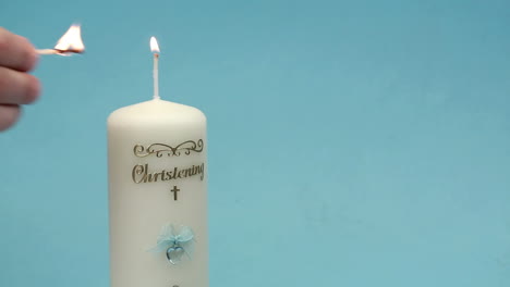 hand lighting christening candle