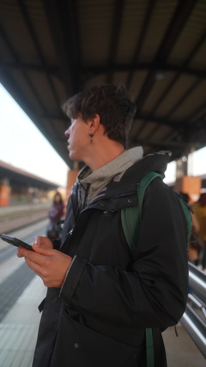 Person using phone at train station