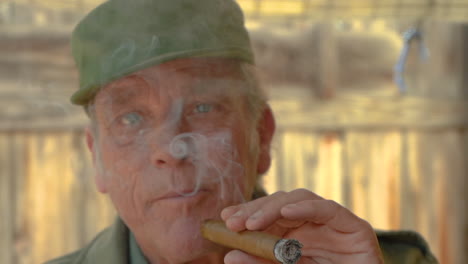 closeup portrait of a handsome mature male puffing a cigar