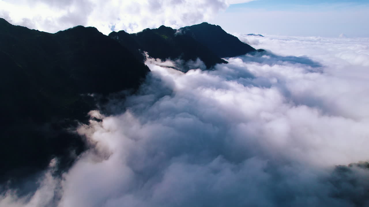 Forward-moving drone shot of clouds-covered Nepal's hill landscapes
