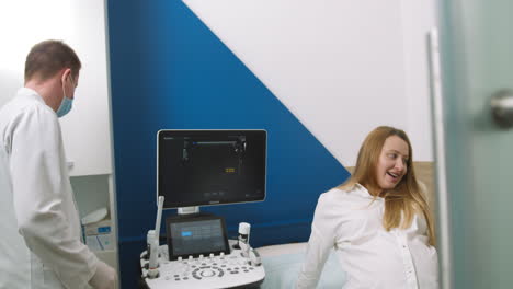 pregnant woman undergoing ultrasound scan with doctor
