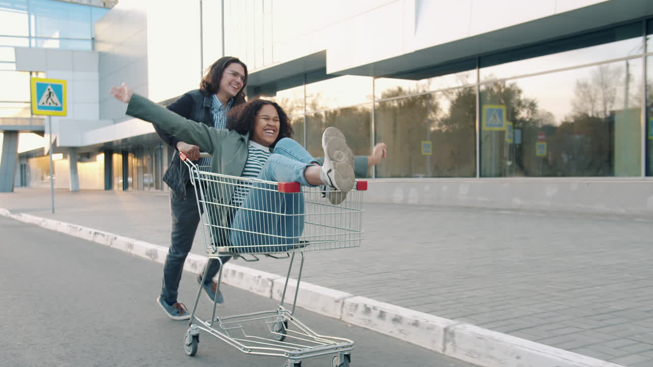 Couple having fun with a shopping cart