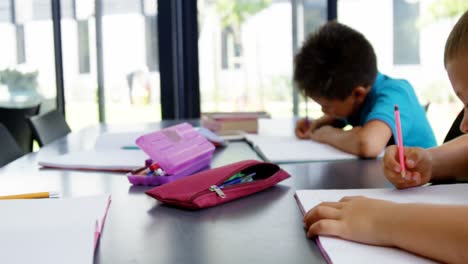 school kids doing homework in classroom