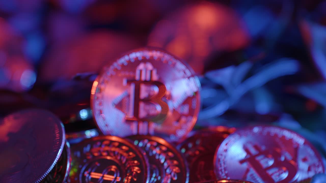 Fade in of Silver Bitcoin laying in more bitcoins close up. finance, business.