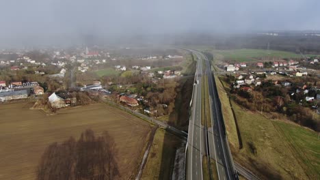 Blizzard-Starting-Over-Highway-on-a-Sunny-Day-Aerial-4K