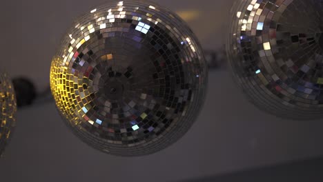 retro party decoration with disco balls shining on dance floor