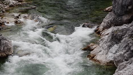 white water from a river cascading down a rocky mountainous canyon in norway