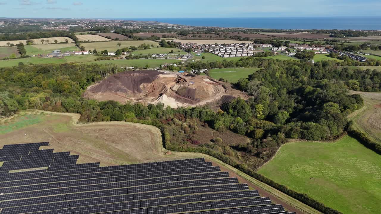 Birds eye view drone aerial Rows of solar farm renewable energy panels photovoltaic green grid sustainable clean power plant eco natural resources with quarry in the background