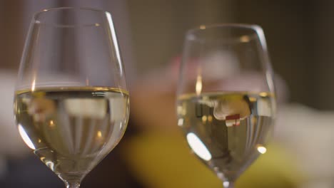 Close-Up-Of-Two-Glasses-Of-Wine-On-Romantic-Evening-At-Home-In-Lounge-