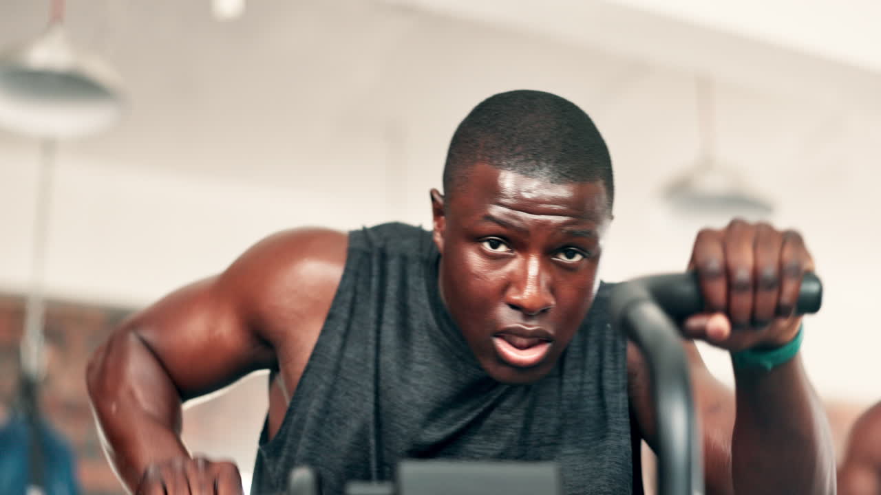 Man intensely exercising on a rowing machine