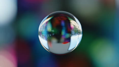 glass sphere reflecting colorful lights with bokeh background