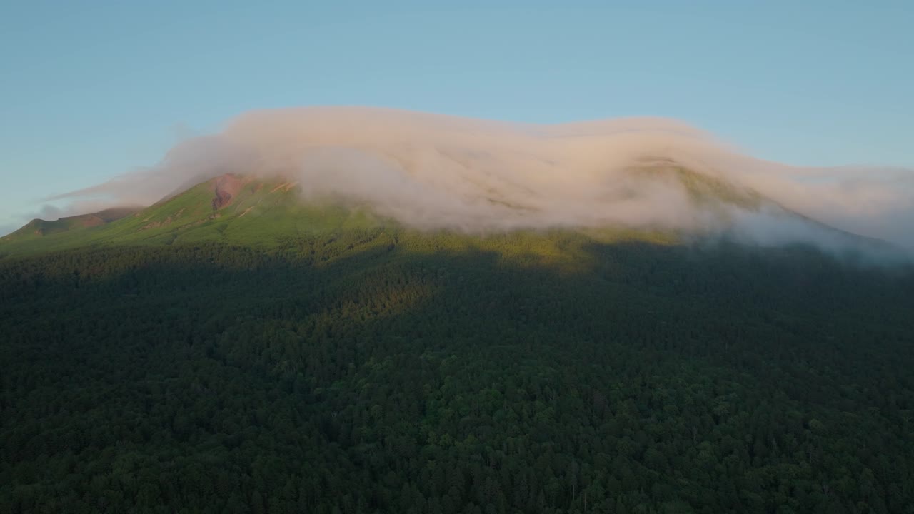 Aerial drone fly forested mountain, sunrise landscape at Onneto National park of Hokkaido Japan, blue skyline at Ainu culture environment
