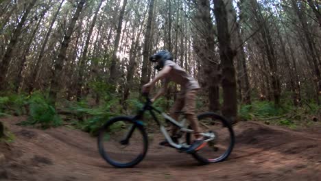 kid on forest mountain bike track pumping speed on bicycle, bright light rays