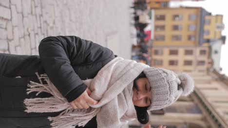 vertical view of female tourist in winter clothing traveling in stockholm old town, sweden