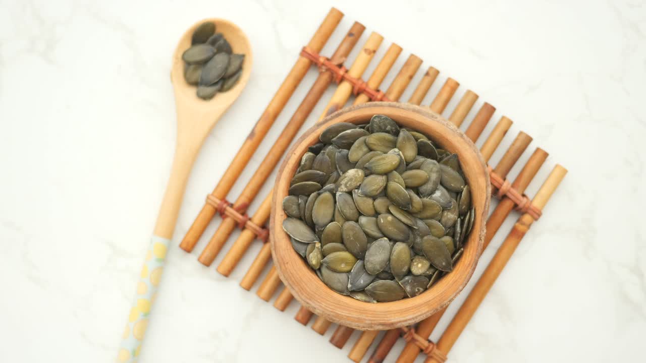 Pumpkin Seeds in Wooden Bowl