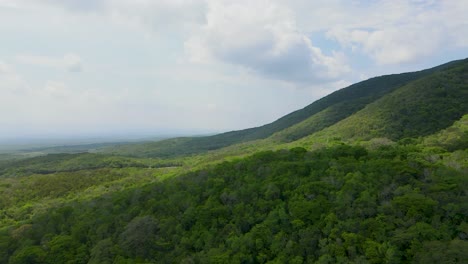 mexico tropical mountain landscape green jungle hills with cumulus clouds forming overhead in the blue sky