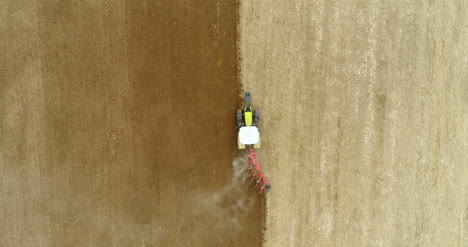 agriculture wide shoot of tractor plowing field 4k 3