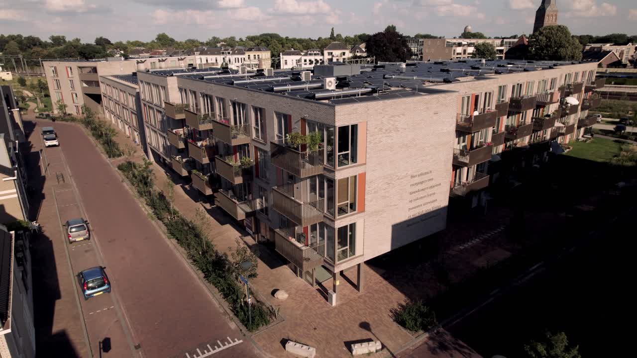 Aerial showing Dutch residential complex and infrastructure of Noorderhaven neighbourhood in Zutphen, The Netherlands, seen from above revealing rooftops full of solar panels