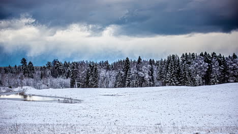 stormy clouds moving in the sky over snowy landscape