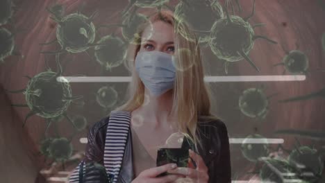 animación de células de covid-19 que se mueven sobre una mujer con máscara facial